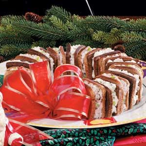 a platter filled with sandwiches and wrapped presents