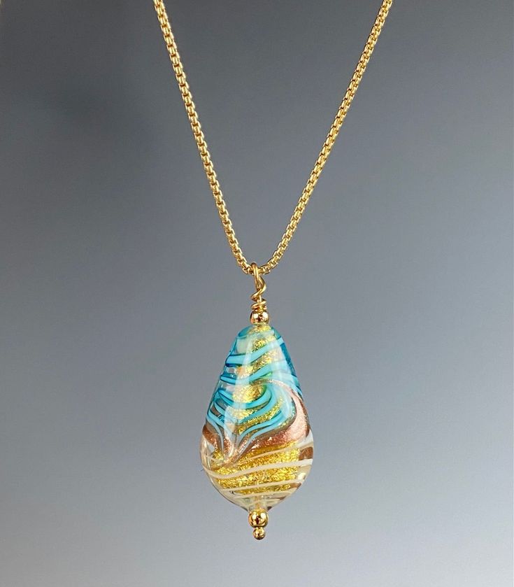 Handcrafted by skilled artisans in the heart of Venice, Italy, this glass bead is made from the finest Murano glass, known for its exceptional quality and unique beauty. Each piece is one-of-a-kind, featuring delicate swirls of color and intricate details that catch the light and shimmer with every movement. The elegant teardrop shape of this pendant adds a touch of sophistication to any outfit, whether you're dressing up for a special occasion or simply adding a pop of color to your everyday lo Artistic Yellow Teardrop Jewelry, Handmade Teardrop Glass Jewelry, Handmade Glass Teardrop Pendant Jewelry, Teardrop Glass Beads For Jewelry Making, Yellow Murano Glass Jewelry Gift, Glass Teardrop Pendant Necklace For Gift, Elegant Glass Teardrop Pendant Jewelry, Artisan Drop Necklace For Gifts, Artisan Drop Necklaces As Gifts