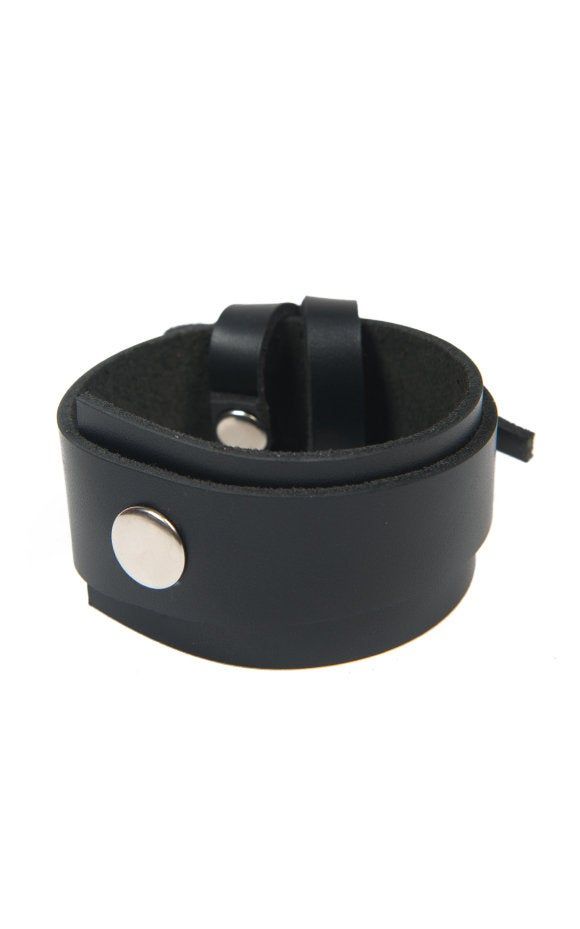 Black Leather Wrist Band - METBR11 Accessories play a huge part in any fashion lover's outfit and with a handmade piece like this one, your style will get a lot of attention! The bracelet is very easy and comfortable to wear, it is light weight and perfect for your daily activities. The best part is it suits many different clothes and other accessories so you don't have to worry about matching it. The bracelet closes with a snap button and its circumference from button to button is about 7 inche Punk Style Leather Cuff Bracelet With Wrist Strap, Black Leather Bracelet For Everyday Use, Punk Leather Cuff Wristband, Adjustable Leather Punk Cuff Bracelet, Leather Punk Cuff Bracelet With Wrist Strap, Punk Leather Cuff Bracelet With Wrist Strap, Black Bracelets With Strap For Everyday Use, Black Bracelet For Everyday Use, Black Punk Cuff Jewelry