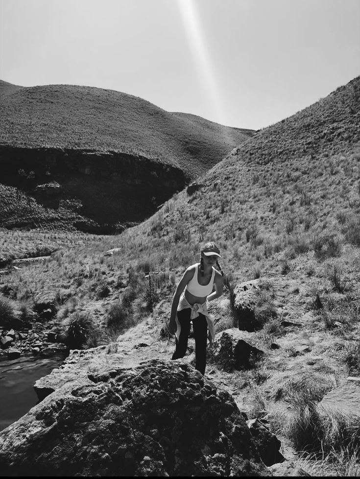 a man standing on top of a rocky hillside