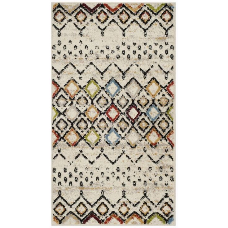 a white rug with multicolored diamonds on it