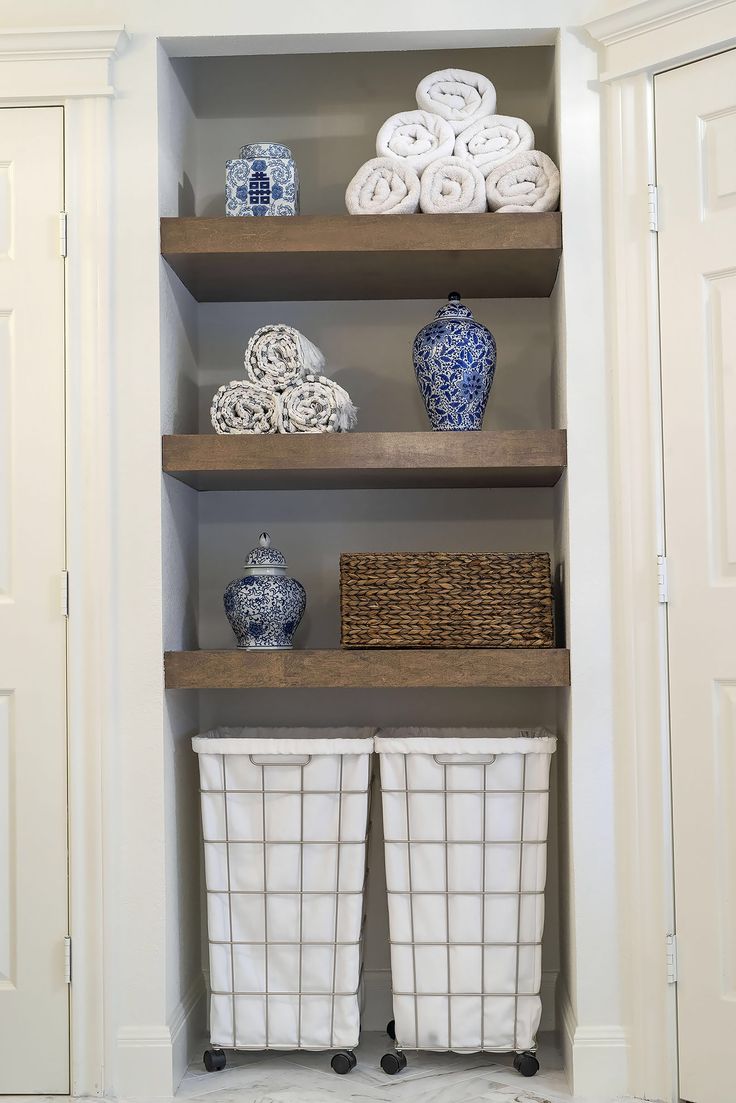 the shelves are filled with blue and white vases, baskets, and other decorative items