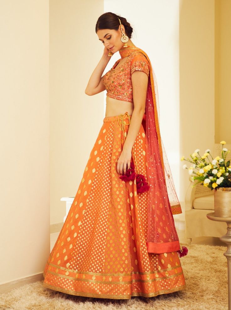 Editor's Note This set features a zardozi embroidered orange brocade lehenga with blouse and dupatta. Color: Orange Fabric: Silk Jaquard And Chanderi Jaquard Embroidery Details: Zardoq Care: Dry Clean Only Customize Your Outfit Can't find the size you're looking for? No stress. Just select the size "Custom" while adding the item to your cart. We will follow up with you for your body measurements. To request a color or design customizations, please contact our customer care by using our "Ask us a Lehenga With Blouse, Brocade Lehenga, Embroidered Orange, Blouse Yoke, Embroidered Lehenga, Casual Tunics, Orange Fabric, Indian Ethnic Wear, Fabric Silk