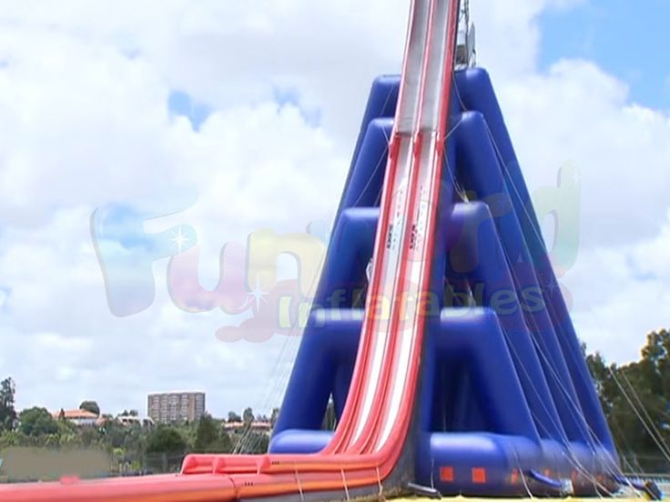 an inflatable water slide is on display at a carnival or party with blue sky and clouds behind it