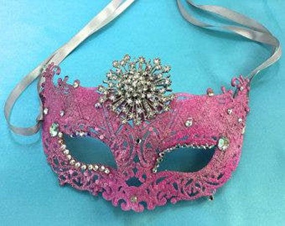 Eye catching masquerade mask sparkles with glitter and rhinestones. Perfect accessory for any formal costume. Rhinestone Mask For Carnival Masquerade, Rhinestone Mask For Masquerade Carnival, Carnival Rhinestone Eye Mask, Rhinestone Masquerade Mask For Mardi Gras Carnival, Masquerade Mask With Rhinestones For Carnival, Rhinestone Eye Masquerade Mask For Costume Party, Mardi Gras Masquerade Mask With Rhinestones For Carnival, Rhinestone Eye Mask For Masquerade Costume Party, Carnival Eye Mask With Rhinestones