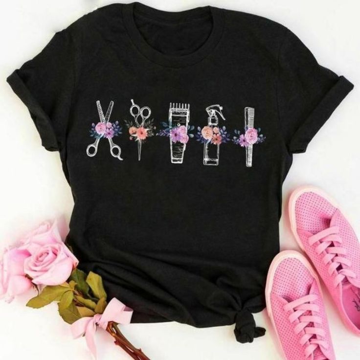 a t - shirt with scissors and flowers on it next to some pink shoes,