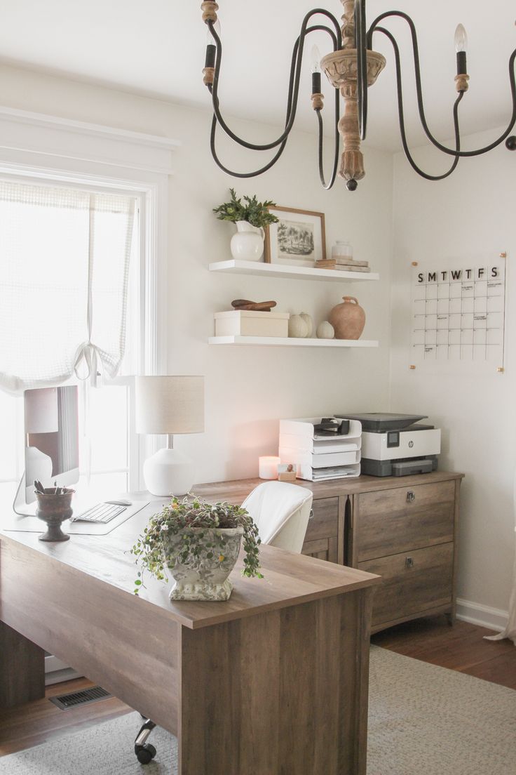 a home office with a desk and shelves on the wall