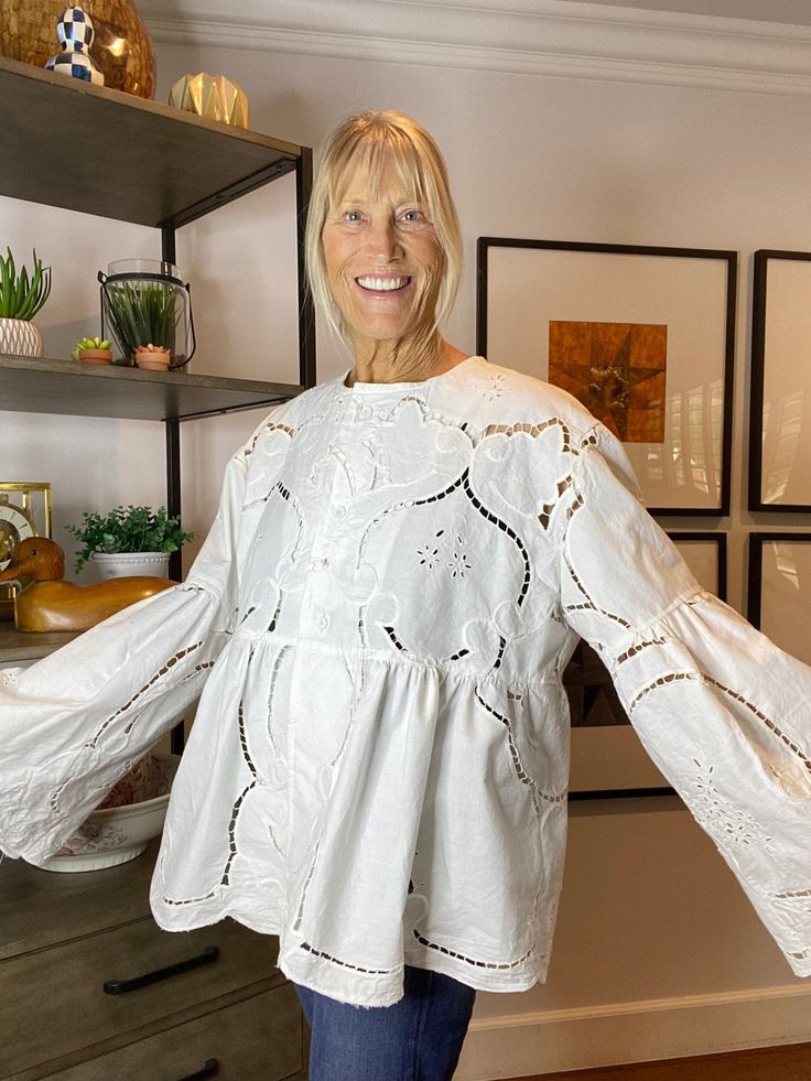 "\"Laurel\"is a one of a kind, Upcycled lightweight blouse made by award winning quilter Karen Carns of Market Street Quilts. This is a real find! Originally a vintage Battenberg lace tablecloth from Beijing, Laurel has been given new life as an important fashion statement. Love the lower sleeves! Fits a US Misses Extra Large with a finished bust measurement of 42\" and a finished length of 25\". Made in our smoke free studio in Arizona. Machine wash and dry." Spring Tops With Cotton Lace Patchwork, Spring Lace Patchwork Cotton Tops, Spring Cotton Lace Blouse With Lace Work, Spring Cotton Lace Blouse With Broderie Anglaise, Long Sleeve Lace Top With Patchwork For Brunch, Long Sleeve Lace Patchwork Top For Brunch, Long Sleeve Blouse For Daywear With Cutwork Hem, White Blouse With Cutwork Hem For Daywear, Broderie Anglaise Cotton Lace Tops For Daywear