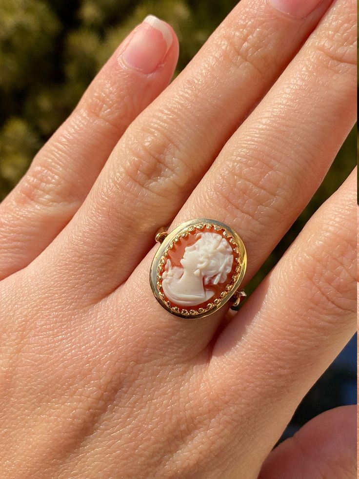 The Veena Ladies Antique Cameo Ring in 14K Yellow Gold. Crafted in 14 karat yellow gold, this ring is in excellent condition. Currently a finger size 8, this ring can be adjusted in size upon request. Each piece has been hand selected and meticulously identified and graded by a Graduate Gemologist who has been awarded a degree by the Gemological Institute of America (GIA). Please visit our Shop's About Page or our website for more information about our jewelry. Sizing for all rings is an additio Luxury Elegant Cameo Ring, Yellow Gold Cameo Ring Fine Jewelry, Cameo 14k Gold Ring, 14k Gold Cameo Ring, Classic Cameo Yellow Gold Rings, 14k Gold Cameo Ring Fine Jewelry, Cameo 14k Gold Rings For Collectors, 14k Gold Cameo Rings For Collectors, Collectible 14k Gold Cameo Rings