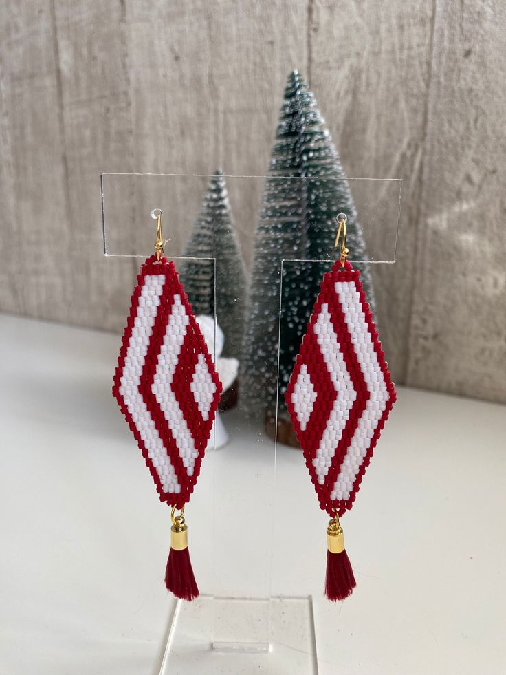 🎅 Handcrafted Miyuki Christmas Earrings, Embodying the Spirit of the Holiday Season! 🎄 Discover a special piece that captures the most magical time of the year! Handcrafted with care and composed of Miyuki beads depicting the Christmas theme, these earrings reflect the joy and festivity of the holiday season. 🌟 With its sparkling details and unique design, it complements every outfit while adding elegance to your style. 🎁 Offers a wonderful gifting option for your loved ones! 🎉 Completes yo Handmade Jewelry For Christmas Celebration, Traditional Christmas Celebration Jewelry, Handmade Earrings For Holiday Celebrations, Handmade Earrings For Celebrations And Holidays, Handmade Christmas Earrings For Celebration, Holiday Handmade Earrings For Celebration, Handmade Jewelry For Holiday Celebration, Handmade Jewelry For New Year Holiday, Handmade Christmas Celebration Earrings