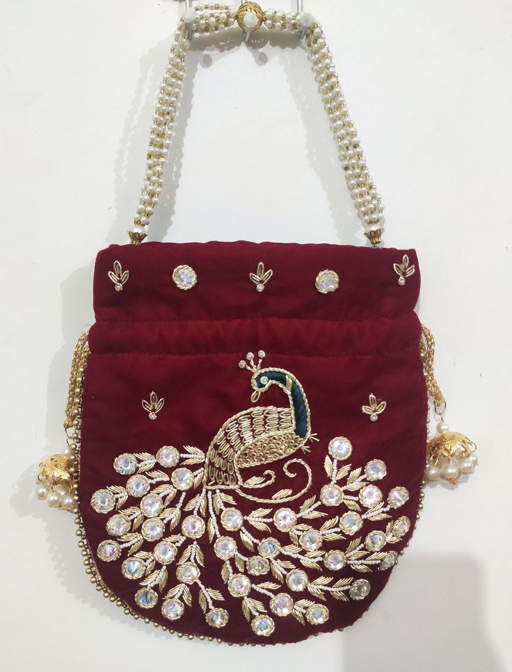 This beautiful Potli or batawa bag are eye catchy and made of premium material. Key Features: Potli Bag Dimension --- 10*8 Inches Embroidery art work This potli is good match with both Indian and western outfits and are superb for wedding and festive parties This would be best complement to your designer saree, lenhga or any other kind of dress This is the combination of traditional and modern embroidery work This is enough to keep your accessories and all needed essentials and it can be a best Red Rectangular Bags With Zari Work, Red Shoulder Bag For Party And Festivals, Red Bag With Zari Work For Festivals, Red Pouch Clutch For Festivals, Festive Red Embroidered Bag, Festive Red Shoulder Bag With Handwork, Red Embroidered Potli Bag For Party, Red Handwork Potli Bag For Party, Red Bags With Zari Work For Diwali