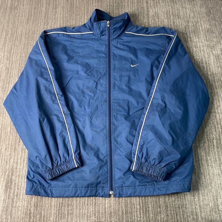 Vintage 2000s Nike Swoosh Check Sportswear Athletic Y2K Aesthetic Streetwear Blue Zip Up Jacket Extra Large Mens Condition: Fair Used Condition = Staining Throughout The Jacket Due To Age And Wear  Measurements: Please see photos above for all measurements IF YOU BUY TWO OR MORE ITEMS USE THE CODE BUNDLE @ CHECK TO SAVE 20% WE SHIP WITHIN 24 HOURS AFTER PURCHASE! Please be aware that we do not offer free returns!! The Buyer is responsible for the cost of the return label.  Follow us on TikTok & Cheap Men's Blue Track Jacket, Blue Nylon Sports Outerwear, Blue Athleisure Outerwear For Streetwear, Blue Nylon Outerwear For Sports, Blue Sportswear Windbreaker With Pockets, Blue Nylon Track Jacket For Sports, Blue Long Sleeve Activewear For Streetwear, 90s Style Long Sleeve Outerwear For Sports Events, Blue Sports Windbreaker