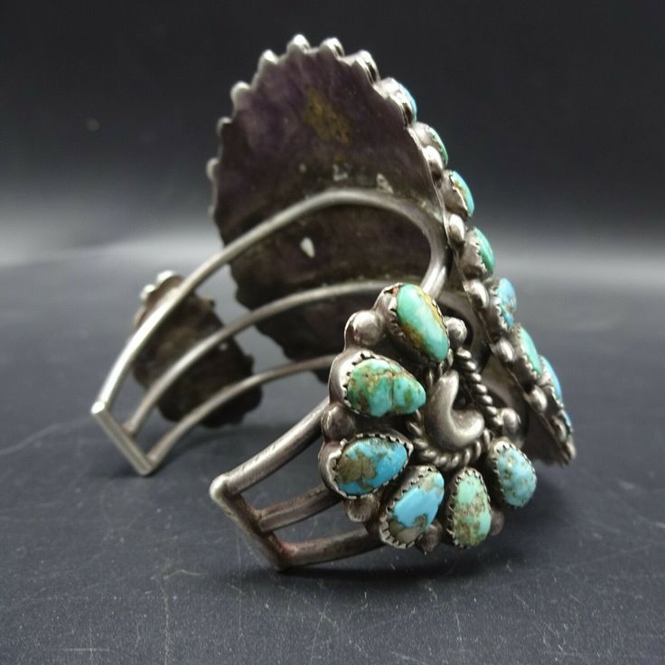 "VINTAGE ZUNI BRACELET DESCRIPTION: This fabulous old cuff features teardrop shaped cabs of old natural turquoise. The gemstones are secure in micro-serrated bezel, on a foundation of heavy gauge vintage sterling silver. The pulled wire cuff holds this beauty nicely in place on your wrist. This extraordinary bracelet will be a cherished addition to your collection of fine vintage Native American jewelry. MEASUREMENTS: Interior of the cuff measures 5 3/8\" with an additional 1 3/8\" slightly adju Vintage Adjustable Gemstone Cuff Bracelet, Adjustable Vintage Gemstone Cuff Bracelet, Vintage Turquoise Bracelet, Vintage Turquoise Oyster Bracelet, Antique Turquoise Bangle, Vintage Gemstone Cuff Bracelet Collectible, Vintage Gemstone Cuff Bracelet, Vintage Gemstone Cuff Bracelet Bangle, Vintage Multi-stone Turquoise Jewelry