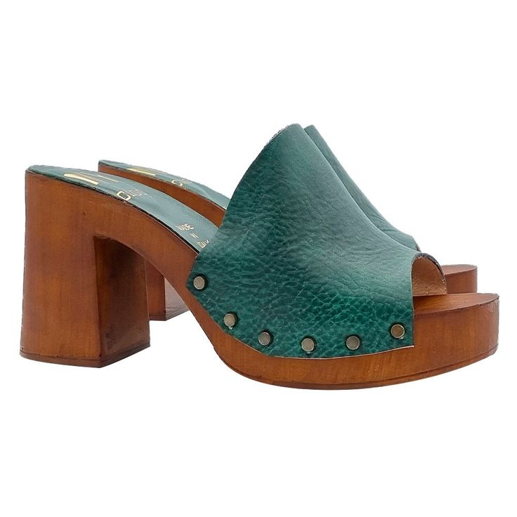 "For a woman, plateau sandals are the winning compromise between a comfortable and comfortable shoe and a pair of sandals capable of slimming the figure thanks to a few more centimeters. Green gives a sophisticated touch, all the quality of Made in Italy at your feet at a great price! Clogs with brown wood effect base Wide band in green leather Heel height 9 cm and plateau 3 cm. Entirely made by specialized Italian personnel Handcrafted using the best materials. Designed & Produced By \"MY Clogs Summer Open Toe Platform Slippers With Leather Sole, Summer Leather Platform Slippers With Leather Sole, High Heel Beach Clogs, Summer Sandals With Reinforced Heel And Round Toe, Spring Leather Platform Slippers With Wooden Heel, Medium Width Open Toe Sandals With Reinforced Heel, Beach Mules With Padded Heel And Round Toe, Summer High Heel Mules With Reinforced Heel, Green Clogs With Removable Insole