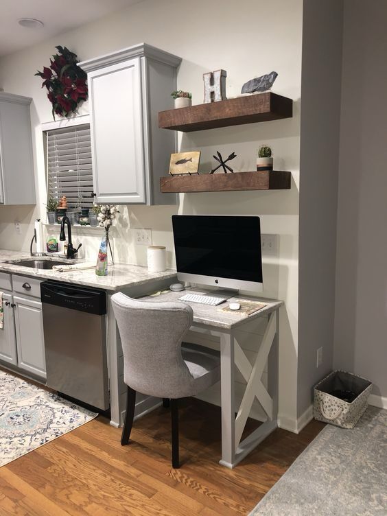 a kitchen with a computer desk and chair next to a stove top oven in it