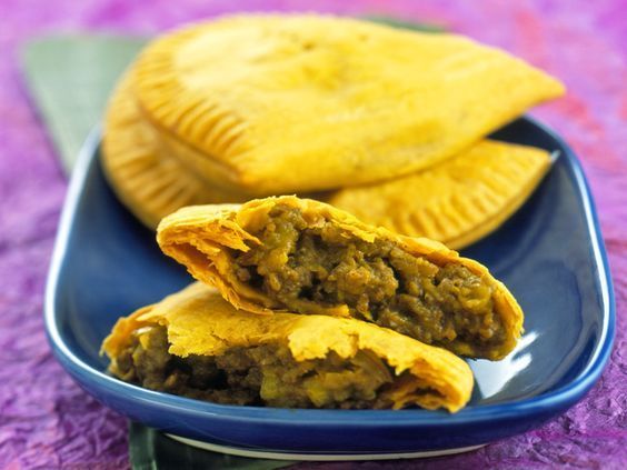 two pastries on a blue plate with a purple tablecloth and green napkins