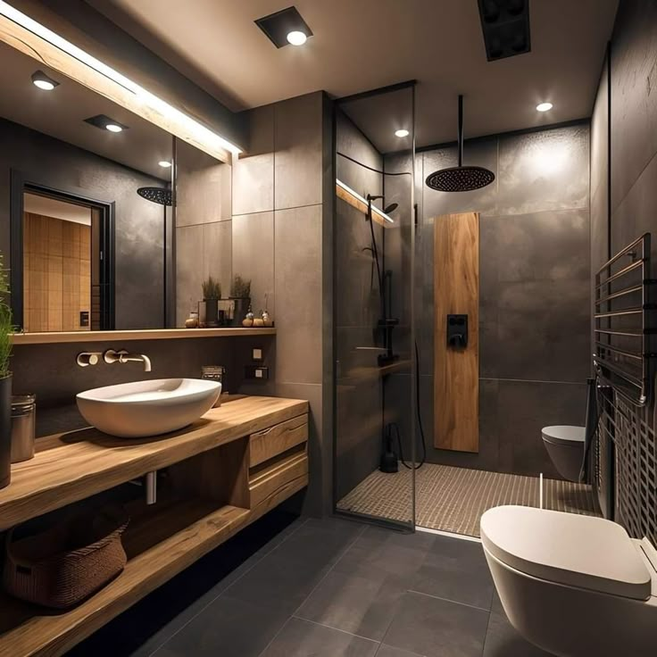 a bathroom with a sink, toilet and shower in it's stall area at night