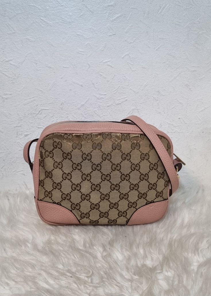 Gucci GG Monogram Bree crossbody bag. Features a GG monogram and pink leather exterior and adjustable crossbody strap. Fabric lined interior with multiple compartments. Top zip closure, and side GG charm. Please view pictures and read descriptions to know the condition of the bag.  Exterior has some canvas wear around the edges. Scuffs around leather piping and bottom edges. Interior is discoloured and abrasions on strap. Fading on zipper head/ hardware. Cute piece. No damage and no added accessories. W - 8.7 x H - 6.7 x D - 2.8 inches Gg Monogram, View Pictures, D 2, Pink Leather, Crossbody Strap, Cross Body Handbags, Purses And Handbags, Crossbody Bag, Bathing Beauties