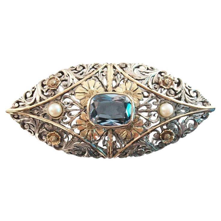 Art Nouveau Aquamarine and pearl brooch set in silver and gold - featuring a bezel set emerald shape Aquamarine to the center (approx. 4.02 carat weight - 11 mm. x 9 mm. x 6 mm. each) - flanked by two cultured pearls (4 mm. diameter) - hand made concave silver filigree setting with 14K yellow gold applied flowers, bands and bezel - original clasp with safety catch and hinge - 14K gold pin (acid tested) - no hallmarks - France - circa 1900. Excellent antique condition - no loss - no damage - no r Gold Pin, Antique Brooches, Pearl Brooch, Silver Filigree, French Art, Silver Pearls, Antique Art, Cultured Pearls, Bezel Setting