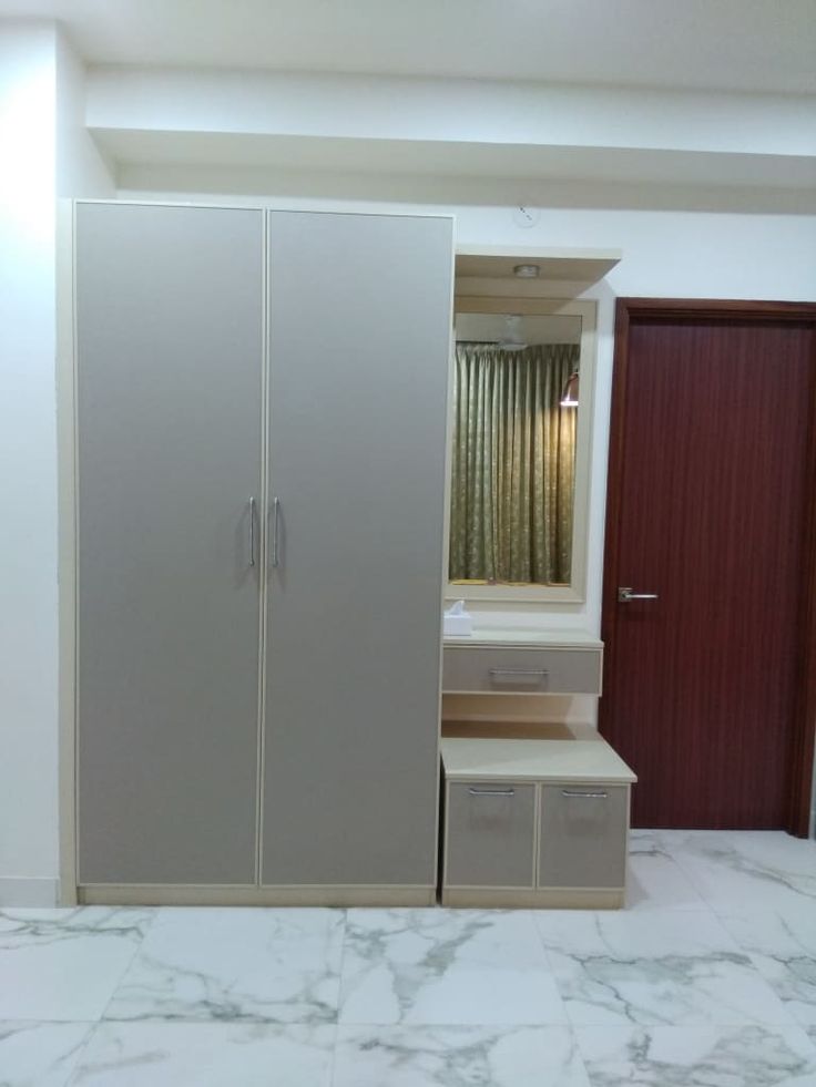 a bedroom with marble flooring and closets next to it's door open