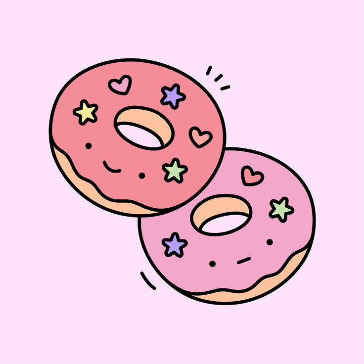 two donuts with sprinkles and hearts on them are sitting side by side