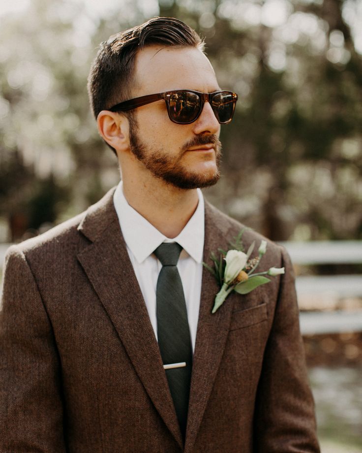 a man in a suit and tie wearing sunglasses