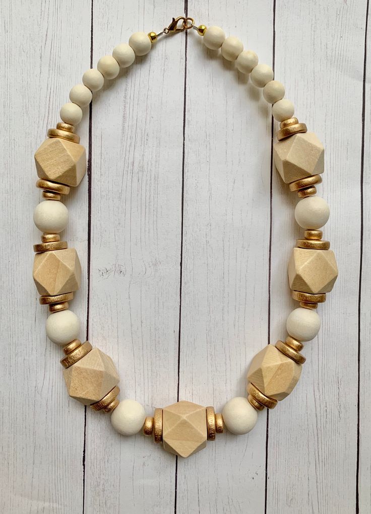 This is an ultimate neutral, chunky beaded long necklace! An easy necklace to add to any outfit. It measures approximately 18 inches with a lobster clasp. Thanks so much for stopping by Beaded Blues! Short Statement Necklace, Easy Necklace, Chunky Bead Necklace, West Lafayette, Chunky Bead Necklaces, Wood Bead Necklace, Chunky Beads, Gold Cream, Short Necklace