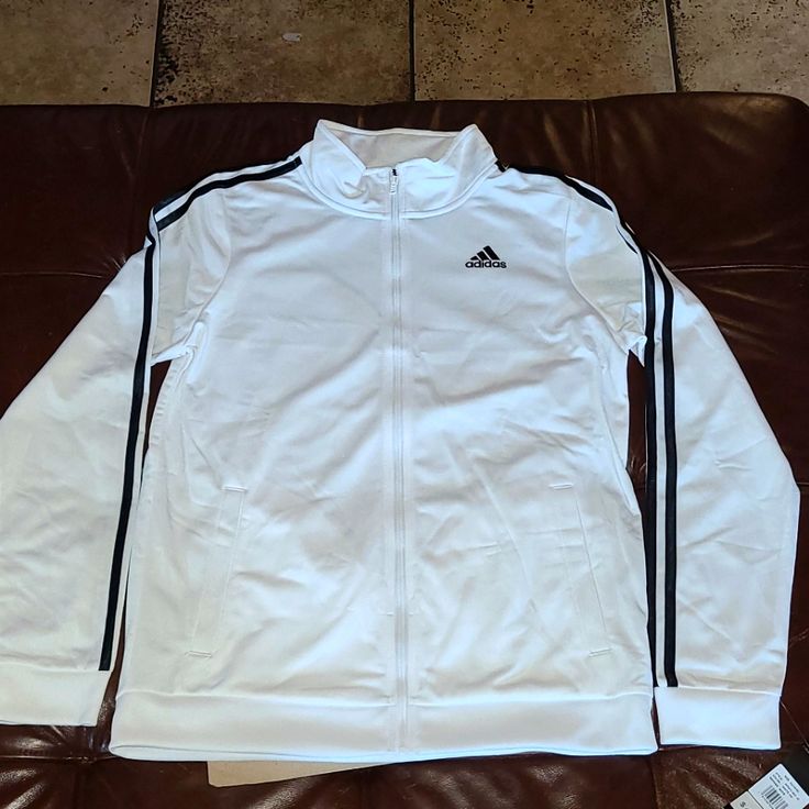 Brand New Size Boys X-Large Addidas With Tags Color White Black Strips White Hooded Track Jacket Athleisure, White Hooded Track Jacket In Athleisure Style, White Hooded Athleisure Track Jacket, Hooded Track Jacket With Three Stripes For Fall, White Hoodie Track Jacket Sportswear, Casual Three Stripes Track Jacket With Long Sleeves, White Hooded Track Jacket For Winter, Casual Three Stripes Long Sleeve Track Jacket, Adidas Cotton Track Jacket In Casual Style