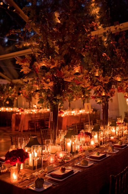 a long table with candles and flowers on it is set up for a formal function