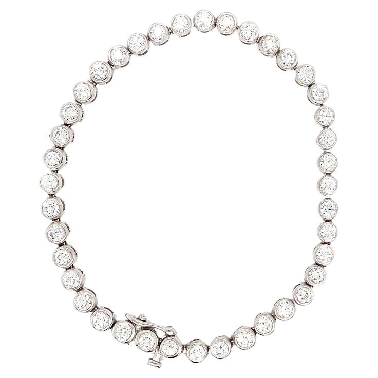 This stunning 5.20 carat round brilliant diamond tennis bracelet features a bezel rubover setting style and is crafted from 18k white gold. The bracelet is adorned with a beautiful pearl secondary stone and a lustrous pearl main stone. The brand of this elegant piece is Brilliant and the theme is art. This item is perfect for those who appreciate fine jewellery and is a great addition to any jewellery collection. 40 diamond ston in total, Round brilliant cut diamond total weight 5.20ct F VS1, 7.5 inches length, hallmarked, all set in 18k white gold with secure double strong clasp. Accompanied by valuation. Elevate your jewellery collection with this exquisite 18k white gold tennis bracelet adorned with 5.20ct round brilliant diamonds and lustrous pearls. The bezel setting style adds an ele White Gold Cross Pendant, Gold Tennis Bracelet, Bracelet Tennis, Gold Topaz, Modern Bracelets, Diamond Tennis Bracelet, Gold Cross Pendant, British Art, Diamond Drops