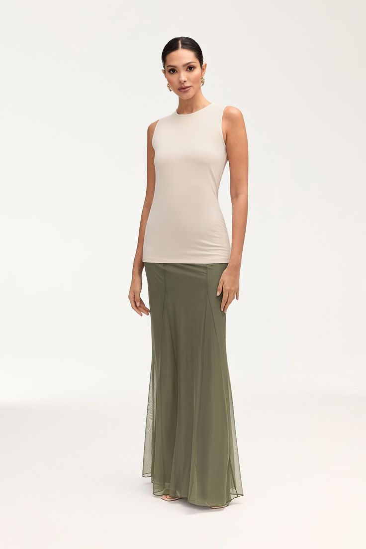 Indulge in elegance with our Milia Mesh Maxi Skirt in Smokey Olive. This skirt features intricate princess seam detailing and godets, making it a luxurious statement piece. The mesh material adds a touch of allure, making it perfect for any upscale event. Model is 5'7" and is wearing size S/44". Please note this garment runs tight. We kindly recommend choosing one size up from your usual size. Mesh Maxi Skirt, White Dress Formal, Dresses Flowy, Nikkah Dress, Engagement Dresses, Kids Outerwear, Dress Satin, Basic Dress, Ribbed Dresses