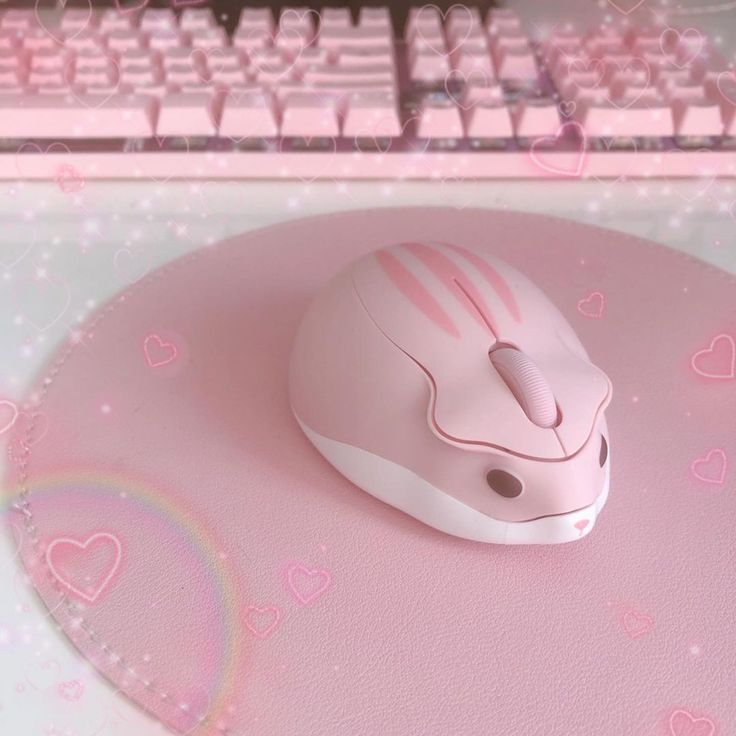 a computer mouse sitting on top of a pink surface