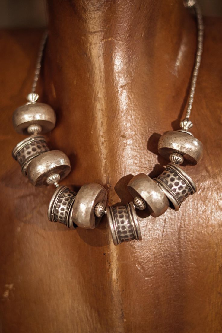 🌟 Discover the elegance of our Rustic Handcrafted Silver Bead Necklace! 🌟 This exquisite necklace is a true masterpiece, featuring 110 grams of pure silver meticulously handcrafted by skilled artisans. With a length of 17 inches, extendable to 19 inches, this necklace offers both versatility and timeless beauty. Intricate Design and Expert Craftsmanship: Each bead of this necklace is crafted with precision and care, showcasing the artisan's dedication to their craft. The detailed patterns and Spiritual Large Beads Jewelry For Festivals, Adjustable Silver Beads Necklace For Rituals, Adjustable Large Beads Jewelry For Rituals, Traditional Necklace With Large Beads And Round Pendant, Bohemian Necklace With Polished Round Beads, Bohemian Necklaces With Silver Beads For Rituals, Bohemian Silver Beads Necklaces For Rituals, Festival Adjustable Silver Beads Necklace, Bohemian Beaded Necklaces With Silver Beads