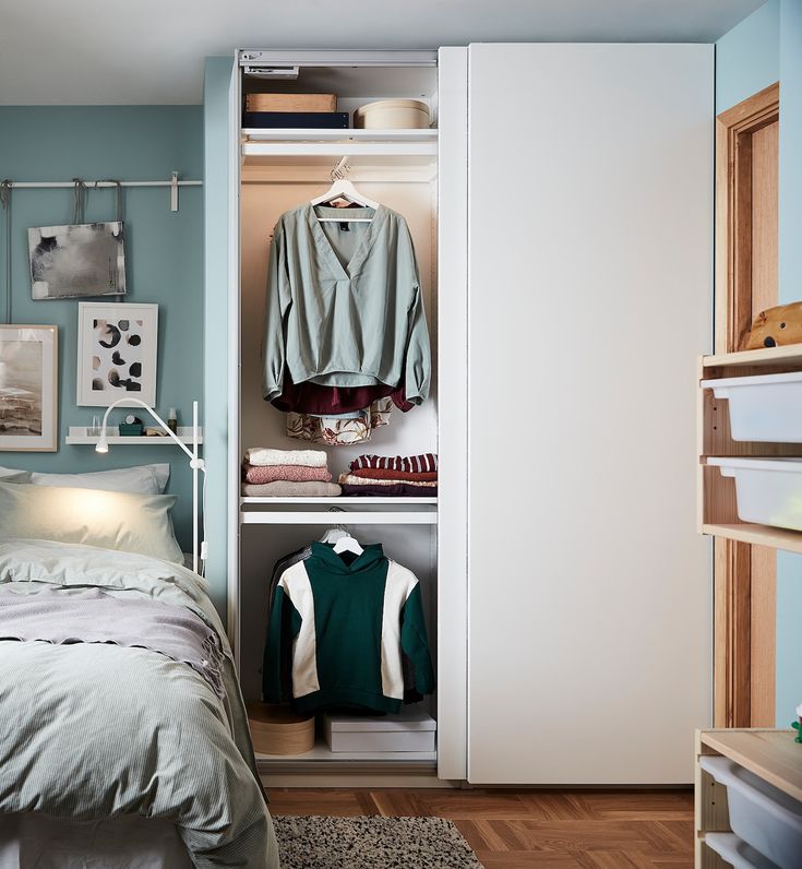 a bedroom with an open closet and bed