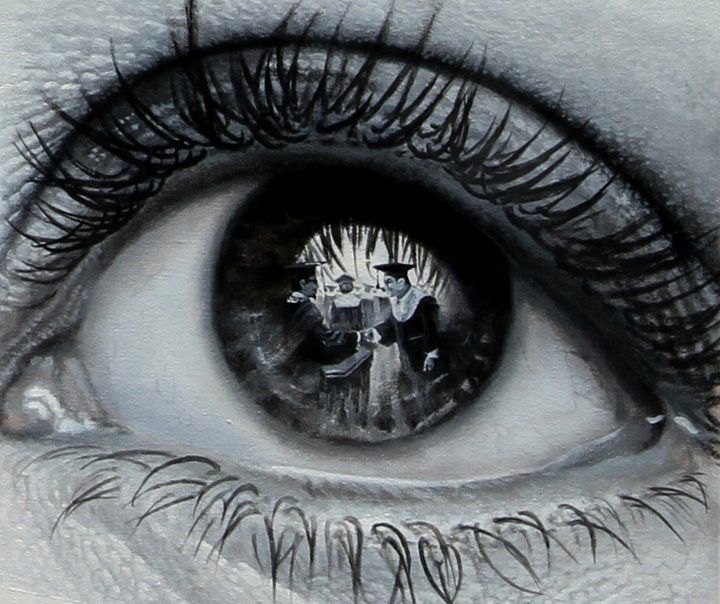 an eye with the reflection of two people on it's irise, as well as some black and white ink