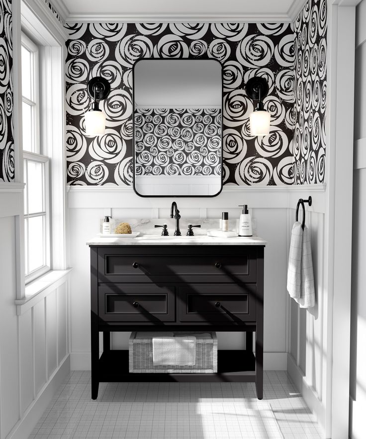 a bathroom with black and white wallpaper, two sinks and a large mirror on the wall