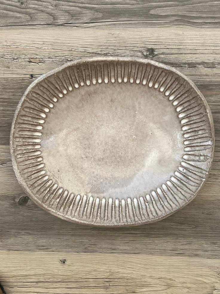 a white plate sitting on top of a wooden table next to a pair of scissors