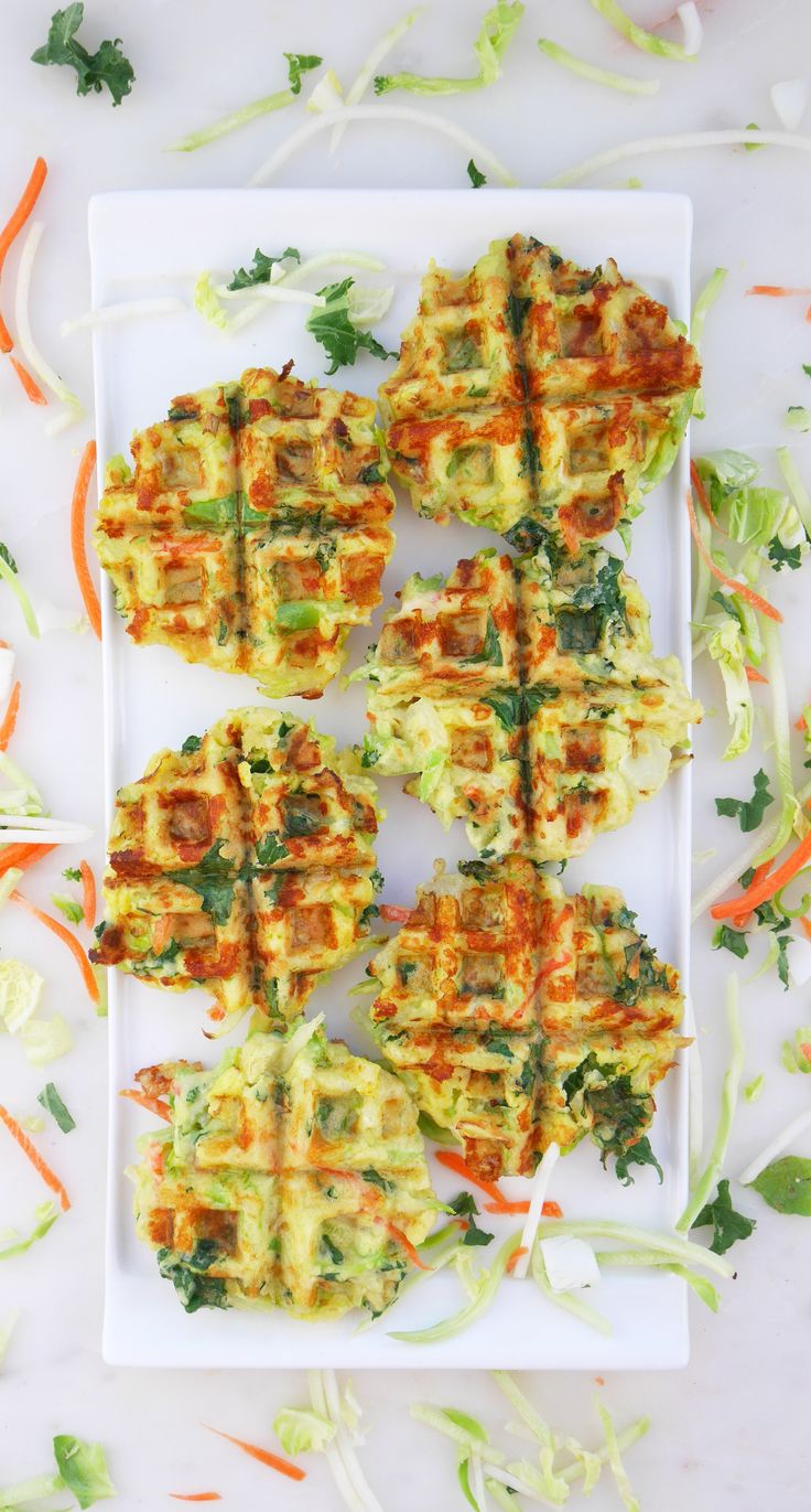 some food on a white plate with carrots and lettuce