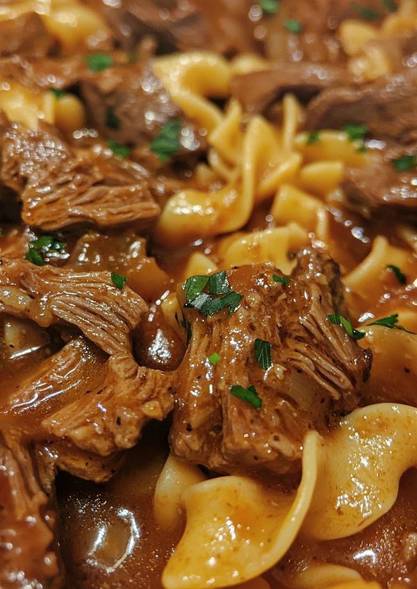 pasta with beef and sauce in a bowl