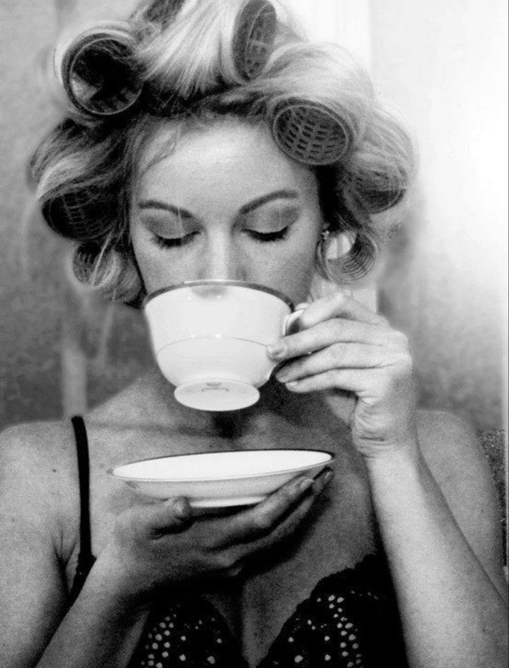 a woman drinking from a coffee cup