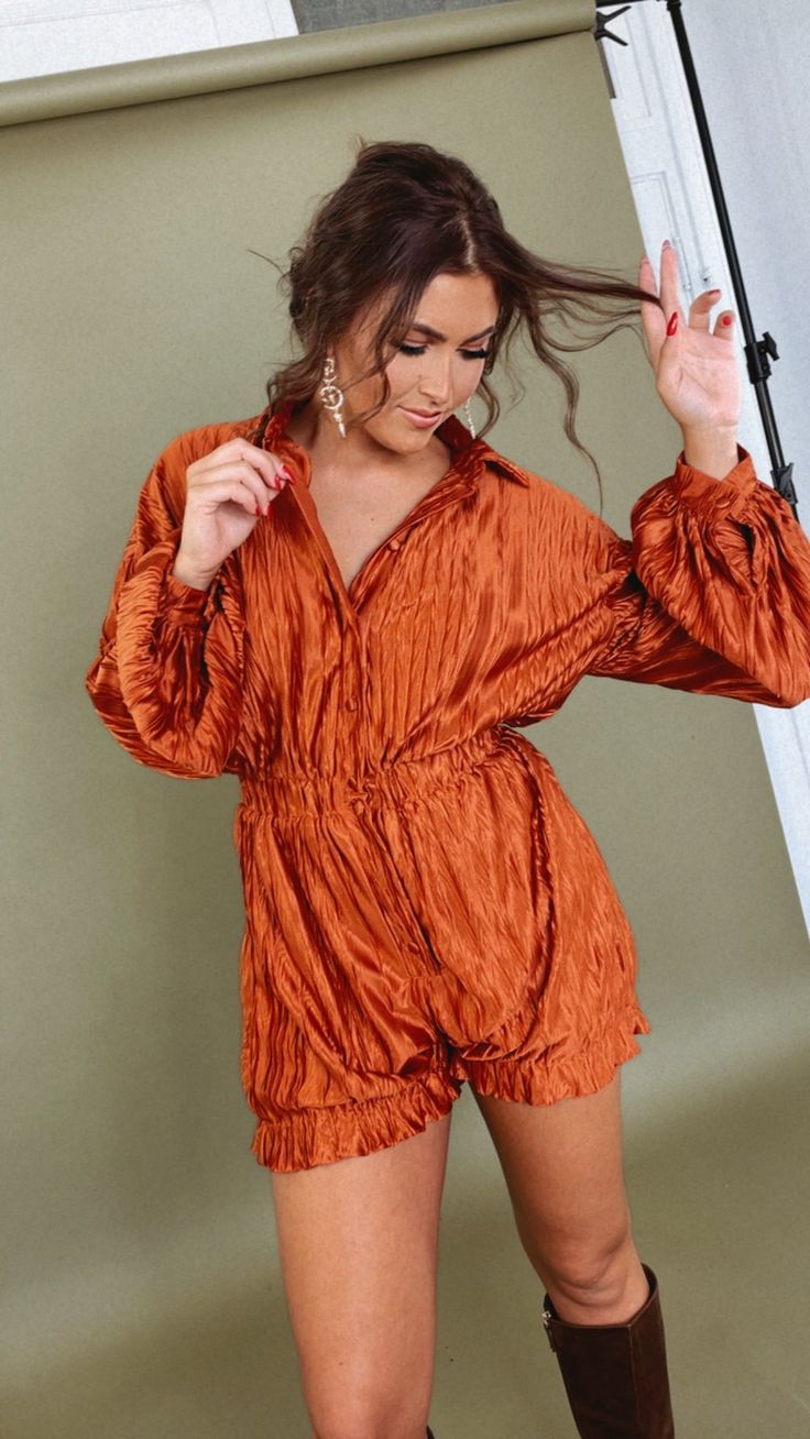 The Set, The Tone Romper in Terracotta, is a trendy and versatile choice for your fall fashion lineup. This romper sets a stylish tone with its beautiful terracotta color, perfect for the autumn season. Textured Elastic Waist Long Sleeve Romper Textured fabric Front buttons down Smocking detailed waist Drop shoulder Basic collared Long balloon sleeve Elastic band at cuffs and waist Fabric Contents: 100% POLYESTER Inseam: S:3.75" - M: 4" - L:4.25" Model Specs: Emily is wearing a size small in the Orange Long Sleeve Jumpsuit For Fall, Brown Jumpsuit For Fall Party, Brown Jumpsuits And Rompers For Fall, Brown Long Sleeve Jumpsuits For Night Out, Summer Long Sleeve Brown Jumpsuits And Rompers, Long Sleeve Brown Jumpsuits And Rompers For Summer, Chic Fall Jumpsuits And Rompers For Loungewear, Chic Orange Long Sleeve Jumpsuits And Rompers, Long Sleeve Jumpsuits For Date Night In Fall