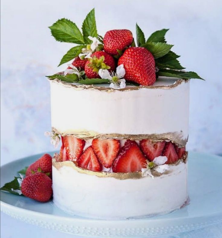 a white cake with strawberries on top and the words, strawberry fault line cake tutor