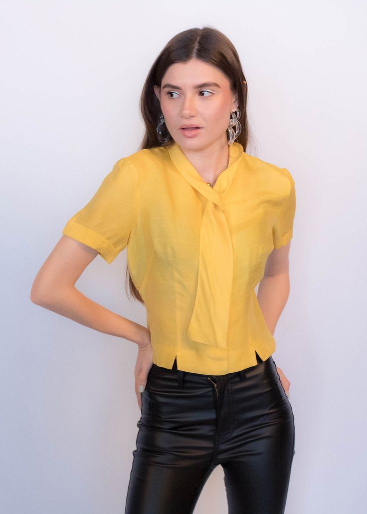 Luxury Semi-stitched Yellow Blouse, Chic Fitted Tie Neck Top, Chic Fitted Top With Tie Neck, Vintage Silk Short Sleeve Blouse, Vintage Silk Blouse With Short Sleeves, Semi-formal Tie Neck Fitted Blouse, Semi-formal Fitted Tie Neck Blouse, Formal Fitted Tie Neck Blouse, Yellow Fitted Top For Office