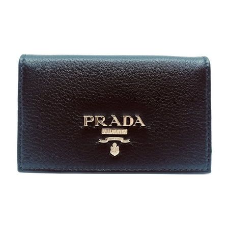 This Prada vitello grain black card holder is absolutely adorable and is the perfect size for your personal information. The pebbled soft leather is sure be the classic accessory you need. The gold Prada Paris logo looks amazing with the simple black leather. Includes authenticity cards and Prada box. Model: 1MC122 Black vitello grain leather Gold-tone hardware Prada Milano Logo Card holder/ wallet Measurements: 4.5" x 1" x 2.5" (LWH) Includes authenticity cards and Prada box Made in Italy Size: S.  Gender: female.  Age Group: adult. Modern Wallets With Logo Plaque For Everyday, Modern Leather Wallets With Logo Plaque, Black Rectangular Card Holder With Logo Plaque, Black Wallets With Logo Plaque For Everyday Use, Black Business Wallet With Logo Plaque, Designer Leather Card Holder With Logo, Classic Black Card Holder With Logo Plaque, Luxury Rfid Blocking Card Holder For Everyday Use, Black Leather Card Holder With Logo Plaque