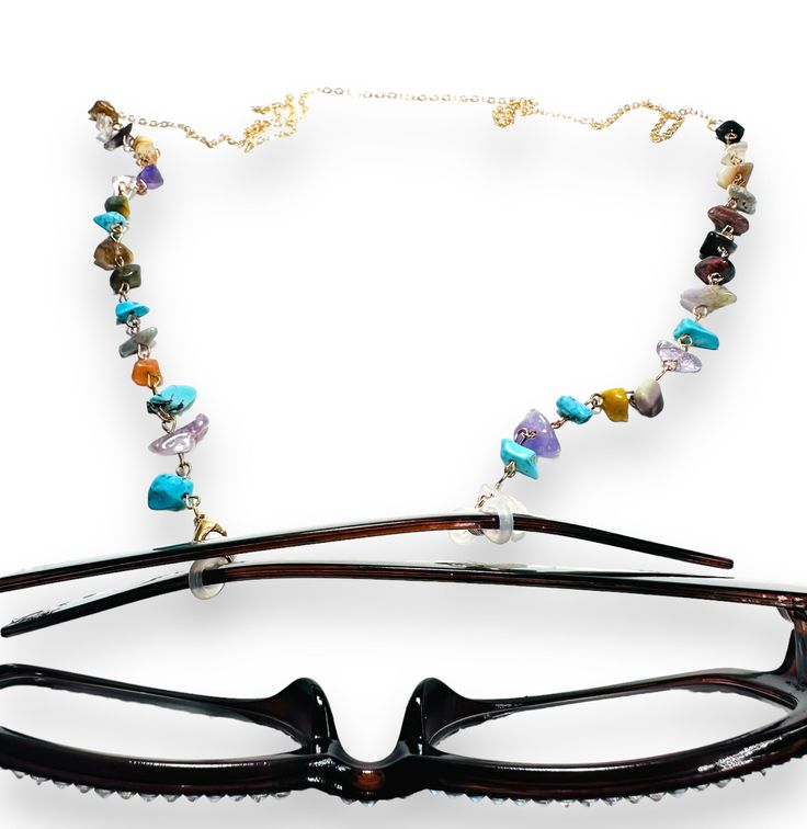 28” long chain with rubber eye glass gaskets to put on the ends of eyeglasses or sunglasses to hold your glasses onto your neck like a necklace. Comes with lobster clasp to transform into a necklace if wanted. Brass, resin and gemstone styles. Designed for convenience and style, this eyeglass holder necklace keeps your glasses close by while adding a chic touch to any outfit. The durable chain ensures secure attachment and the sleek design complements any aesthetic. Keep your glasses easily acce Glass Necklace With Adjustable Chain As Fashion Accessory, Glass Necklace With Adjustable Chain For Fashion, Adjustable Glass Beaded Chain Jewelry, Adjustable Long Glass Necklace, Trendy Glass Jewelry With Lobster Clasp, Trendy Adjustable Glass Jewelry, Eyeglass Holder Necklace, Eyeglass Necklace, Secure Attachment