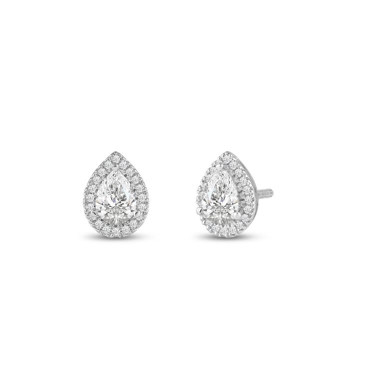 a pair of diamond earrings on a white background