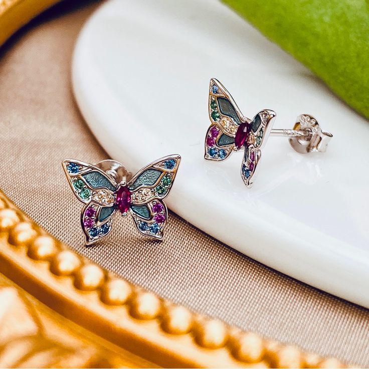 Gorgeous Butterfly Stud Earrings Made Of Sterling Silver Bring A Hint Of Enchantment And Romance To Any Look. Artfully Adorned With Colorful Cubic Zirconia And Enamel, These Feminine Earrings Add Eye-Catching Luxury To Any Outfit. An Exquisite Attention To Detail Gives These Earrings A Delicate Sophistication That Is Sure To Become A Treasured Favorite. Metal: Sterling Silver Hypoallergenic Hallmark: 925 Polished Plating: Platinum Length: 9mm X 12 Mm ***Images Are Taken By Me In My Studio And Ar Hypoallergenic Multicolor Sterling Silver Earrings, Multicolor Sterling Silver Earrings For Gift, Multicolor Hypoallergenic Sterling Silver Jewelry, Hypoallergenic Multicolor Sterling Silver Jewelry, Multi-stone Earrings For Gift, Multi-stone Earrings As A Gift, Multicolor Birthstone Earrings For Gift, Multicolor Enamel Jewelry, Multicolor Sparkling Stones Sterling Silver Jewelry