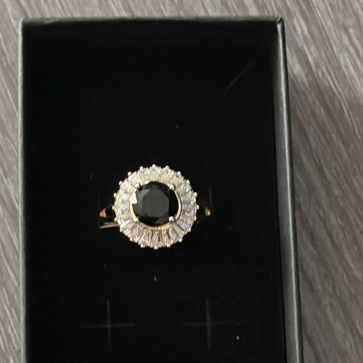 a black and white diamond ring in a box