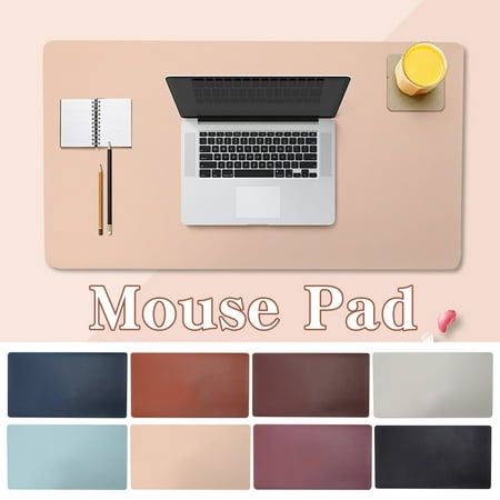 the mouse pad is next to a laptop computer and other items on top of it