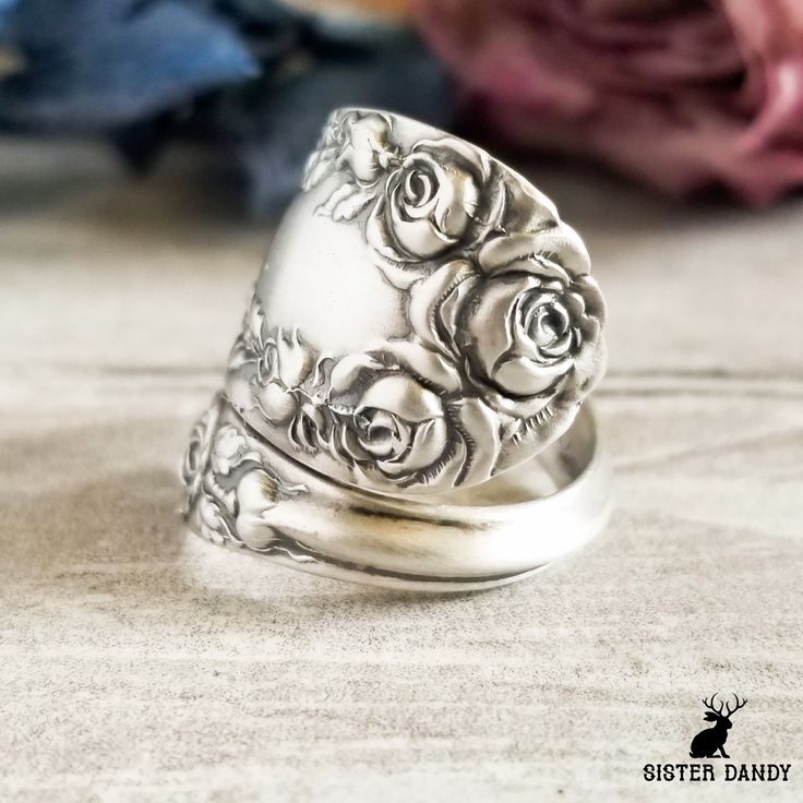 A beautiful vintage rose ring! The original pattern is Normandy Rose made by Northumbria in the early 1900s.  This piece depicts a lovely bouquet of roses at the top with delicate designs down the sides. This ring would make a treasured gift for the lover of plants and nature in your life! This ring is made from a vintage sterling silver spoon, 925, nickel-free. This ring will be adjusted to the size you request but it can easily be tightened or loosened at home should you want a different fit. Vintage Rose Jewelry For Anniversary, Vintage Rose-colored Jewelry For Weddings, Vintage Rose-colored Jewelry For Anniversary, Vintage Rose Wedding Jewelry, Vintage Flower Engraved Ring For Anniversary, Vintage Rose Design Jewelry In Rose Color, Vintage Rose Design Jewelry, Vintage Engraved Flower Wedding Ring, Vintage Silver Jewelry With Roses